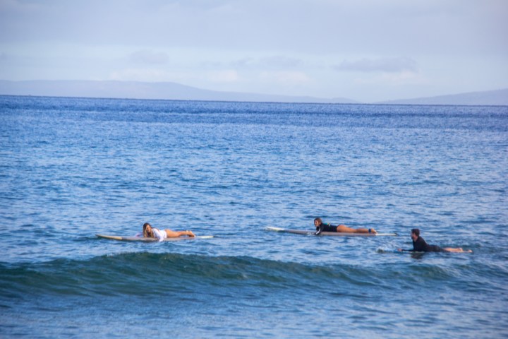 a group of people in a small boat in a body of water