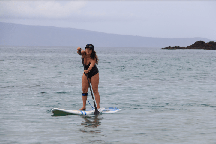 a person riding a surf board on a body of water