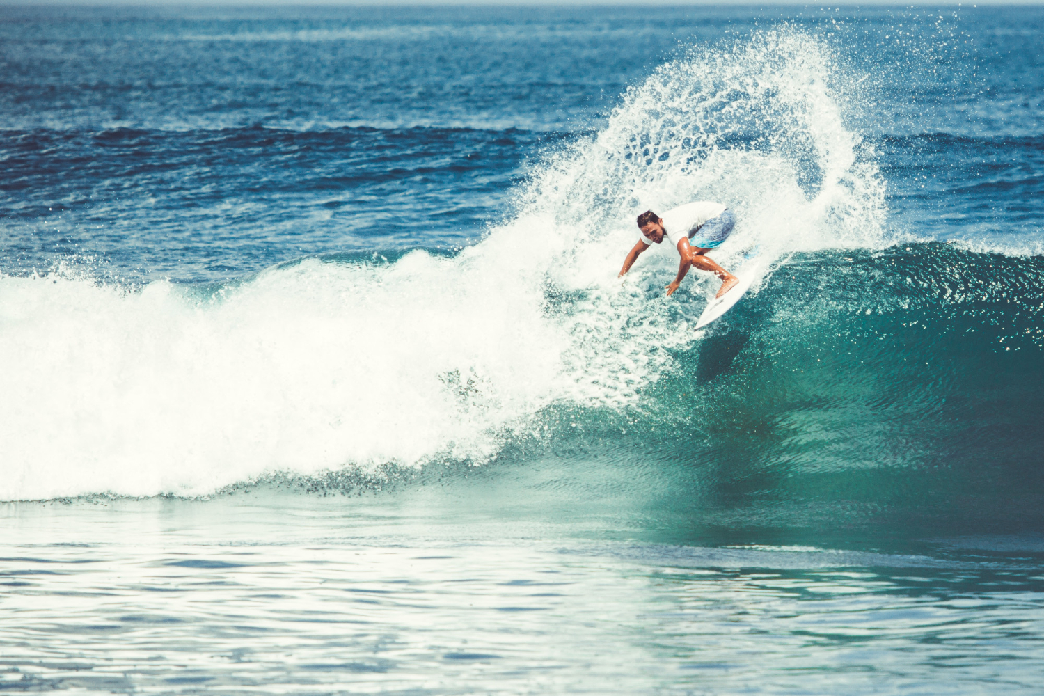 men-girls-are-surfing (1) a man riding a wave on a surfboard in the ocean